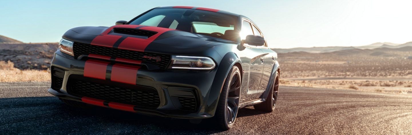 A black 2023 Dodge Charger SRT Hellcat with dual red center stripes.